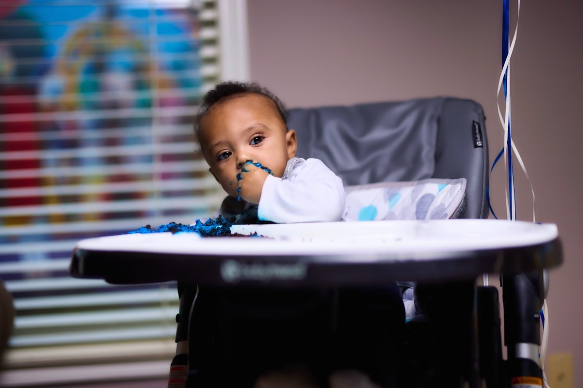 Baby sitting in a white high chair