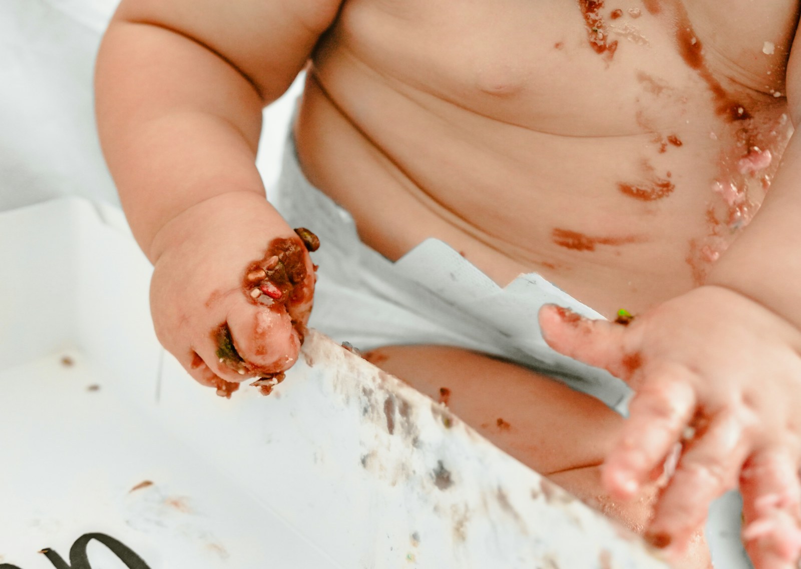 Baby exploring textures and colors with hands during sensory play