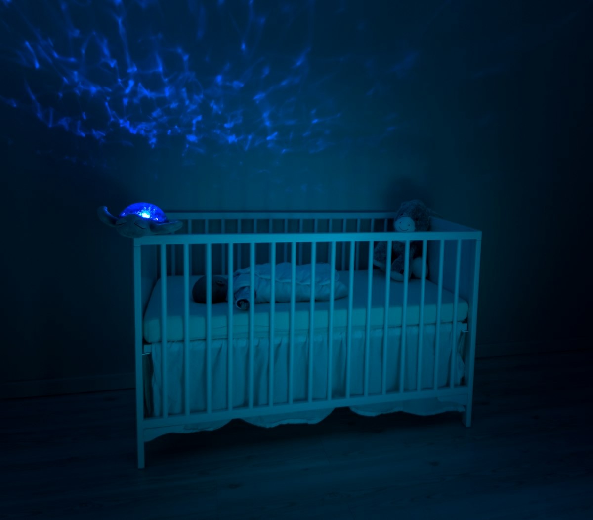 Baby crib in a dim nursery at bedtime