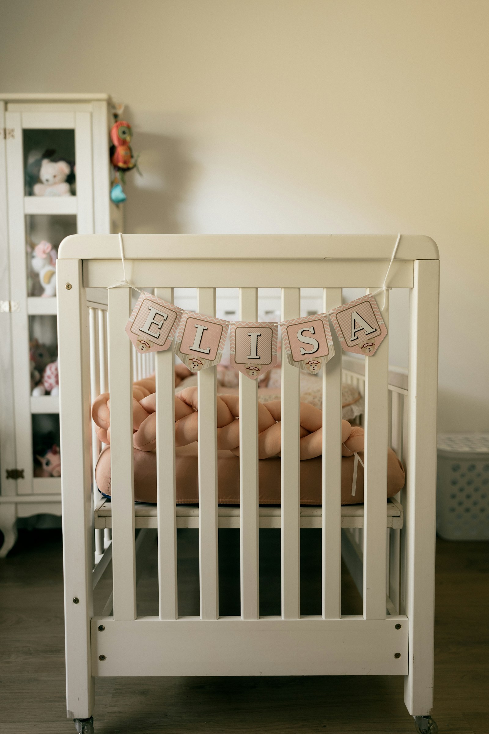 A crib in a calm, softly lit nursery